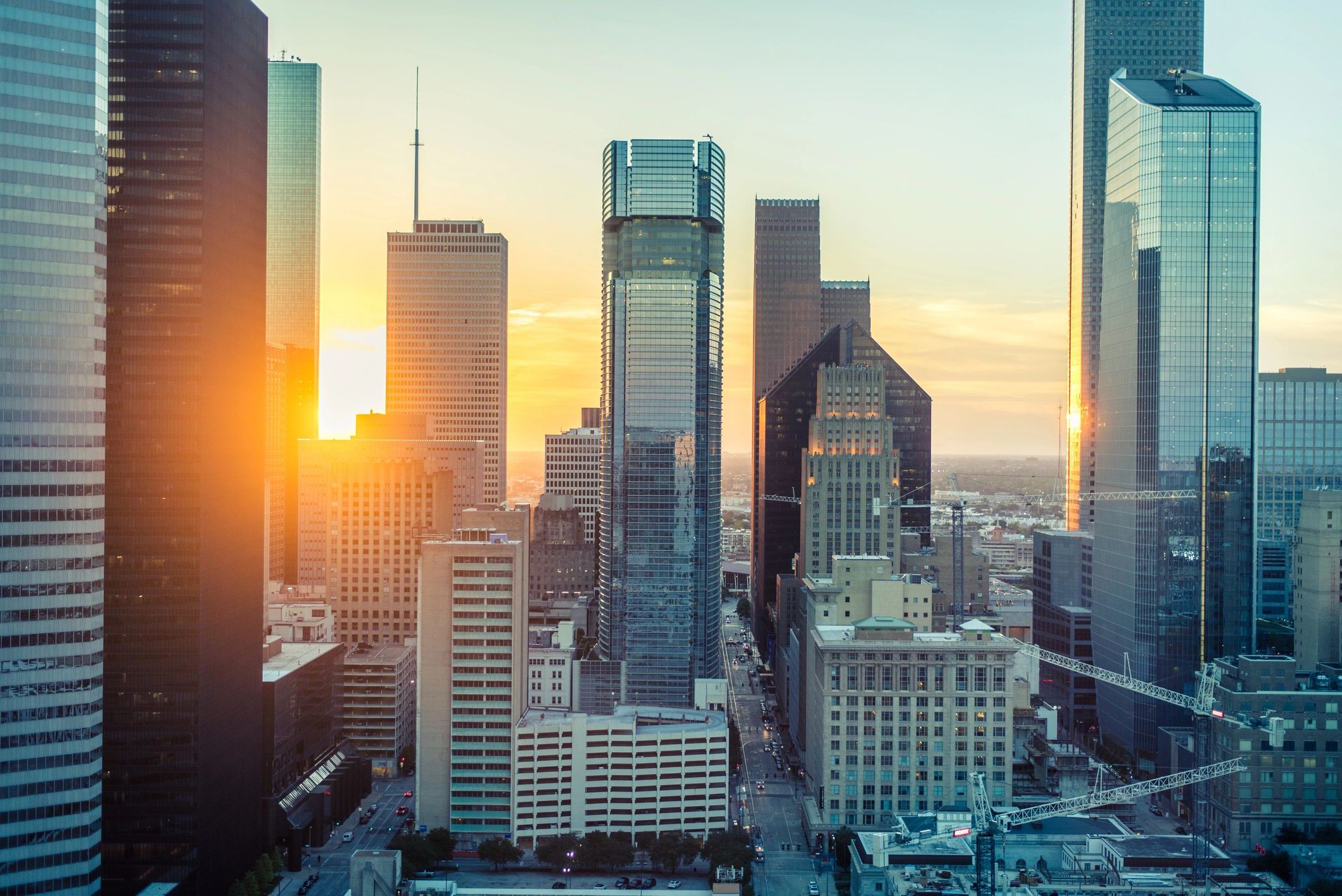 Sunset over a city skyline with skyscrapers.